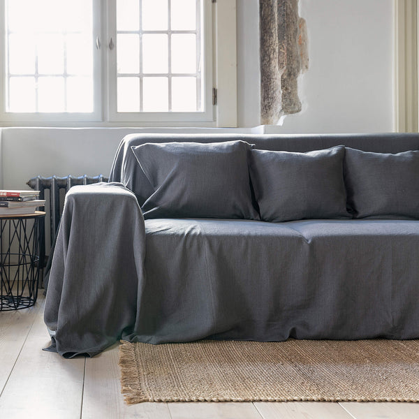 Renew your living space effortlessly with our charcoal grey linen couch cover. Its thoughtful design ensures complete coverage, extending gracefully over the arms. Discover the perfect balance of functionality and elegance with our collection today.