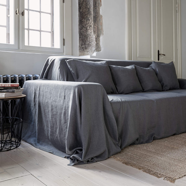 Renew your living space effortlessly with our charcoal grey linen couch cover. Its thoughtful design ensures complete coverage, extending gracefully over the arms. Discover the perfect balance of functionality and elegance with our collection today.