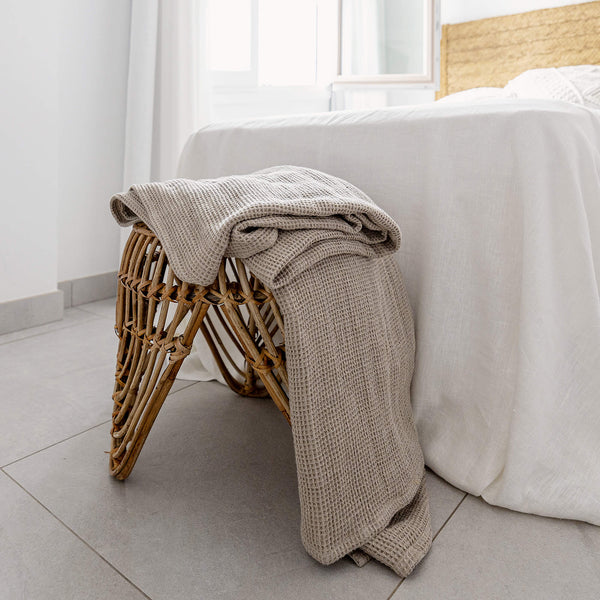 Rustic heavy linen waffle throw crafted from a cozy waffle weave, blanket adds a layer of warmth and style to any bedroom decor.