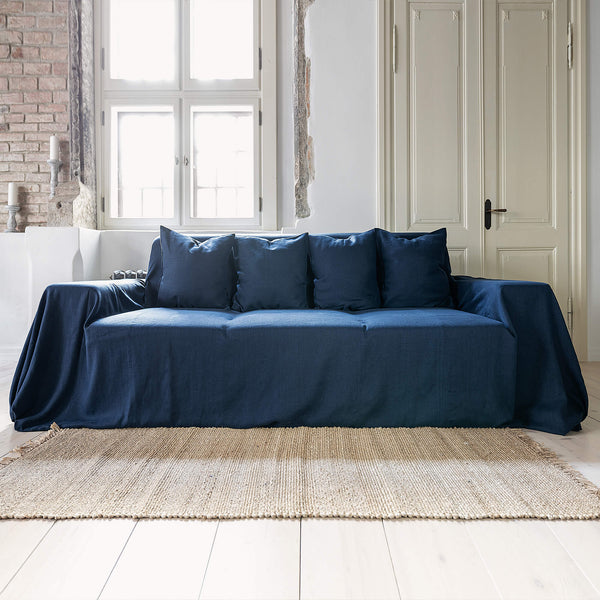 Navy blue linen couch cover designed and crafted to elevate your interior with a fresh look and great energy. It offers a practical solution for safeguarding your furniture against the playful antics of your beloved pets.