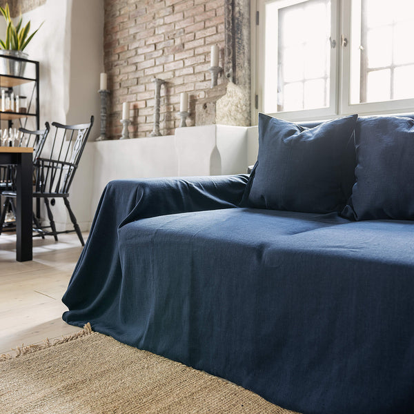 Navy blue linen couch cover designed and crafted to elevate your interior with a fresh look and great energy. It offers a practical solution for safeguarding your furniture against the playful antics of your beloved pets.