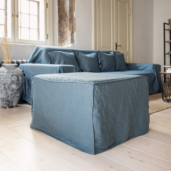 Ocean blue linen couch cover designed and crafted to elevate your interior with a fresh look and great energy. It offers a practical solution for safeguarding your furniture against the playful antics of your beloved pets.