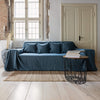 Ocean blue linen couch cover designed and crafted to elevate your interior with a fresh look and great energy. It offers a practical solution for safeguarding your furniture against the playful antics of your beloved pets.