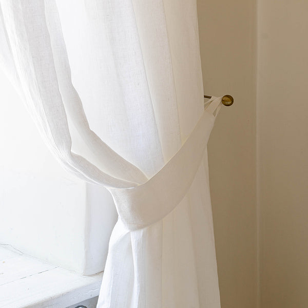 Our optical white linen curtain tie-back the perfect solution to keeping your curtains looking neat and stylish.