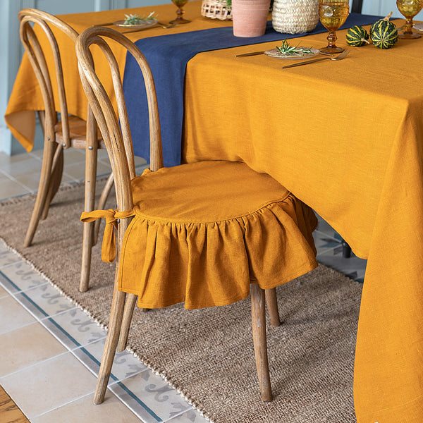 Our amber yellow linen ruffled chair slipcovers offer both practicality and aesthetic appeal. The covers will protect dining chairs from spills and stains, also enhance the visual appeal of your space with their timeless natural style. Slipcovers will simply change your chairs appearance and provide an elegant solution.