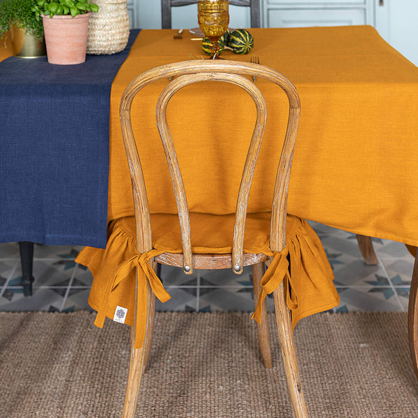 Our amber yellow linen ruffled chair slipcovers offer both practicality and aesthetic appeal. The covers will protect dining chairs from spills and stains, also enhance the visual appeal of your space with their timeless natural style. Slipcovers will simply change your chairs appearance and provide an elegant solution.