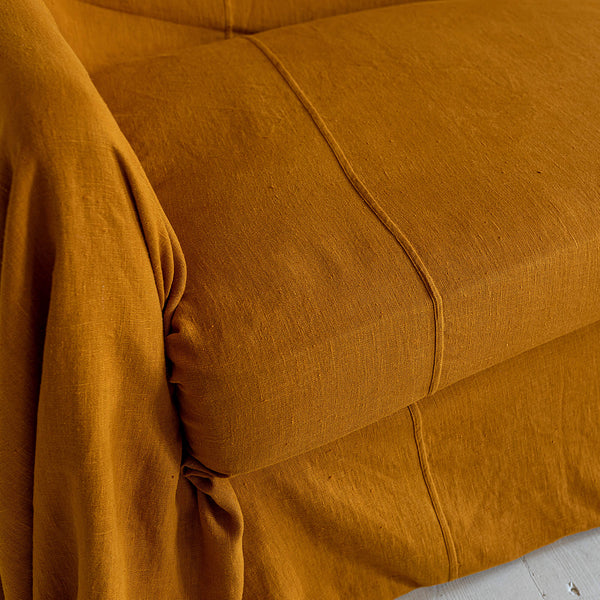 Introducing our Amber Yellow linen couch cover, crafted to enhance the beauty and functionality of your sofa. Designed to shield your couch from daily spills and stains, this cover offers both practicality and elegance.