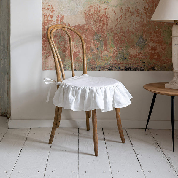 Our antique white linen ruffled chair slipcovers offer both practicality and aesthetic appeal. The covers will protect dining chairs from spills and stains, also enhance the visual appeal of your space with their timeless natural style. Slipcovers will simply change your chairs' appearance and provide an elegant solution.