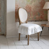 Our Antique white linen chair slipcovers offer both practicality and aesthetic appeal. The covers will protect dining chairs from spills and stains, also enhance the visual appeal of your space with their timeless natural style. Slipcovers will simply change your chairs appearance and provide an elegant solution.