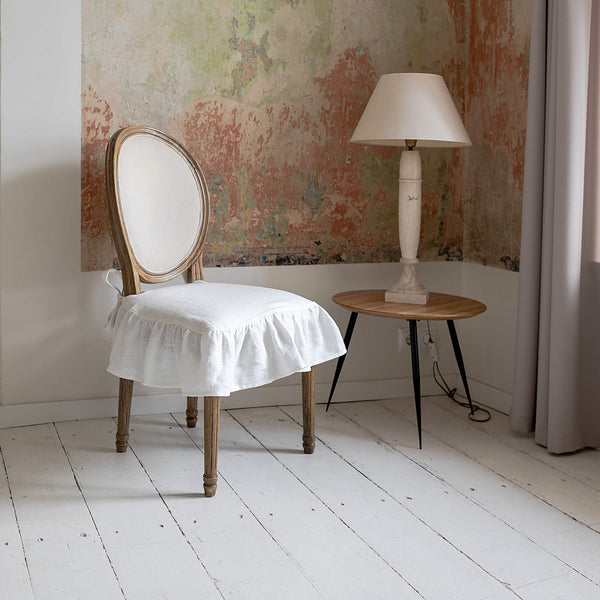 Our Antique white linen chair slipcovers offer both practicality and aesthetic appeal. The covers will protect dining chairs from spills and stains, also enhance the visual appeal of your space with their timeless natural style. Slipcovers will simply change your chairs appearance and provide an elegant solution.