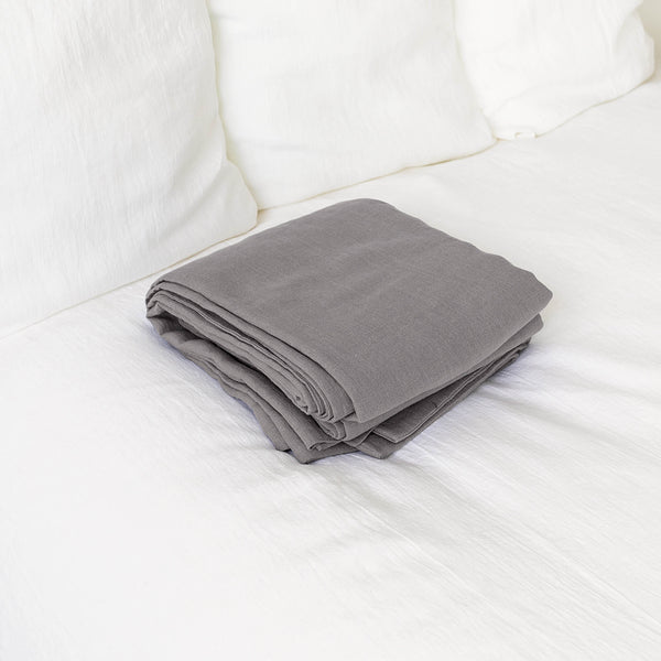 Introducing our luxurious linen flat sheet in a sophisticated charcoal grey colour. Whether you use it as a traditional top sheet for layering with blankets or as a standalone lightweight bedcover, it adds a touch of elegance to any decor scheme.