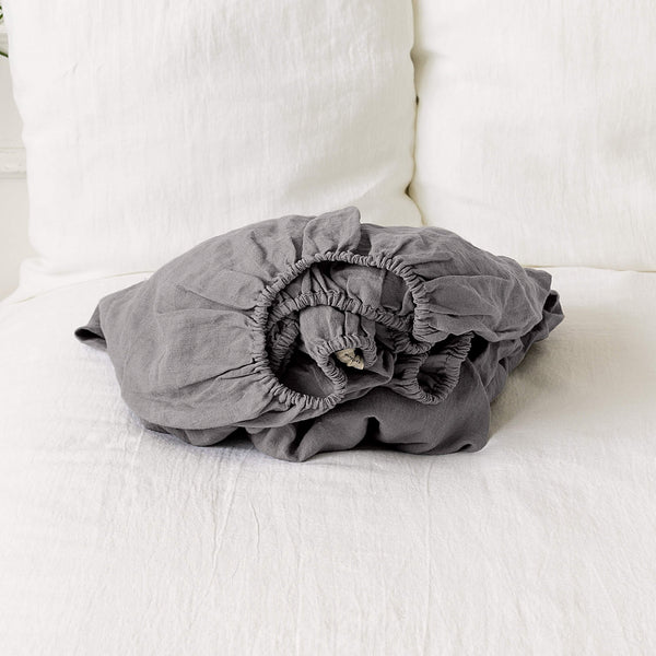 Our charcoal grey linen fitted sheet, the epitome of modern bedroom luxury.Crafted from gentle and breathable linen, these sheets are destined to become a staple in your home.Whether it's the chill of winter or the warmth of summer, these sheets will keep you cozy and comfort.