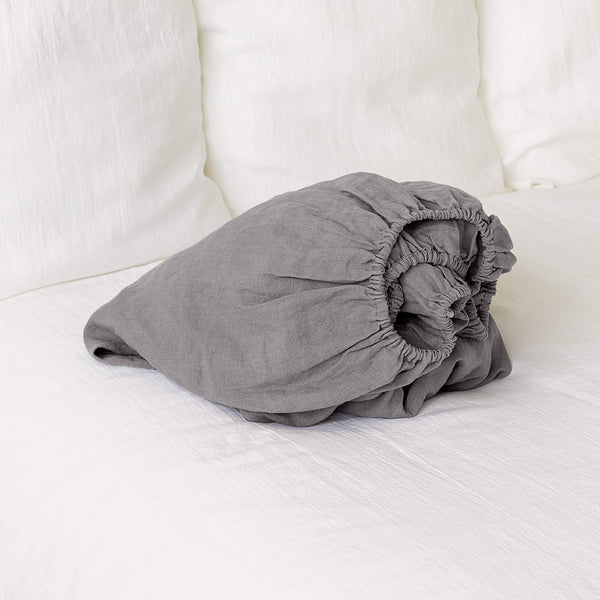 Our charcoal grey linen fitted sheet, the epitome of modern bedroom luxury.Crafted from gentle and breathable linen, these sheets are destined to become a staple in your home.Whether it's the chill of winter or the warmth of summer, these sheets will keep you cozy and comfort.