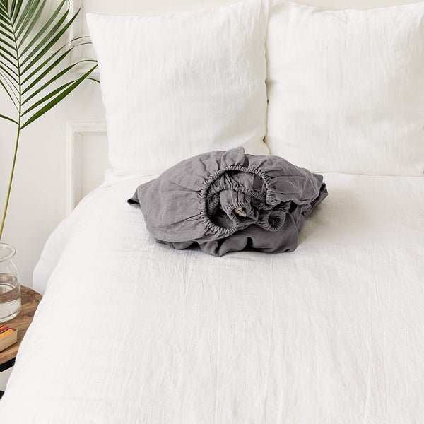 Our charcoal grey linen fitted sheet, the epitome of modern bedroom luxury.Crafted from gentle and breathable linen, these sheets are destined to become a staple in your home.Whether it's the chill of winter or the warmth of summer, these sheets will keep you cozy and comfort.