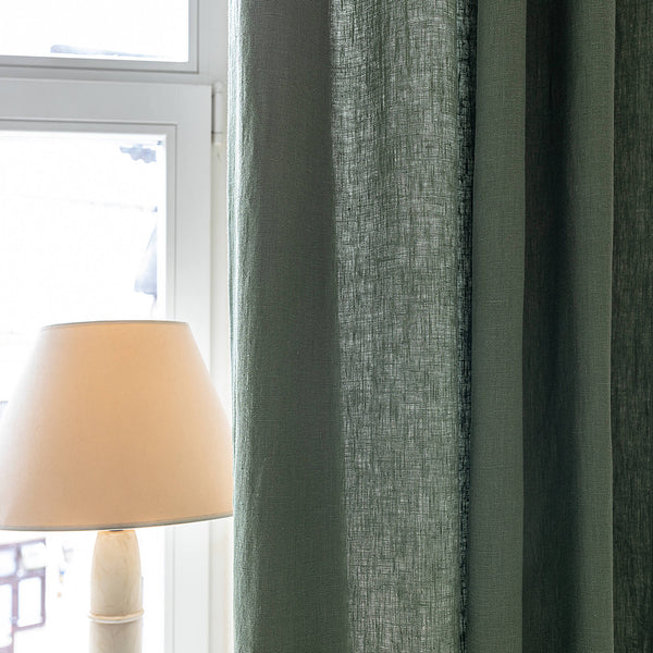 Lined moss green linen curtains with lining, designed and made to provide maximum protection from the sun and heat coming through the window. The natural thermoregulatory properties of linen will help you to create the most comfortable atmosphere.