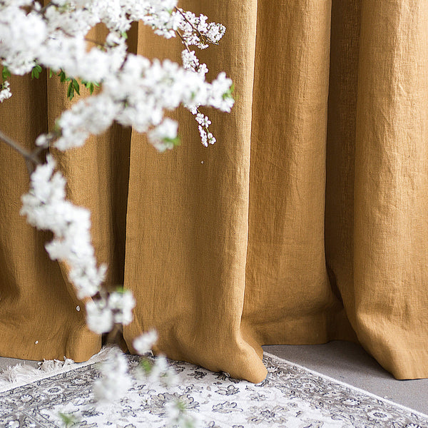 Dusty Mustard curtains with a decorative white floral wreath in front