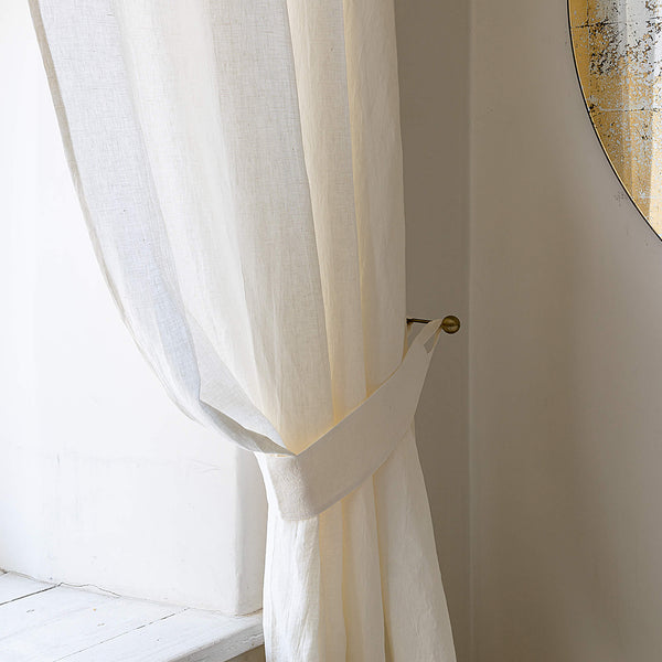 Our off white linen curtain tie-back is the perfect solution for keeping your curtains looking neat and stylish. Made from the highest-quality European linen, they offer durability and a luxurious feel.