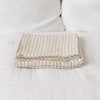 Linen flat sheet, elegantly striped in white and natural tones.Crafted for the modern bedroom, these sheets offer unparalleled softness and breathability, ensuring a comfortable night's sleep year-round.