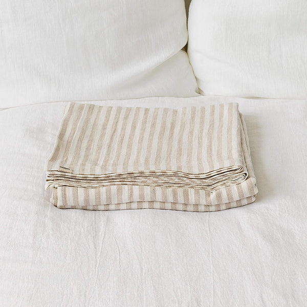 Linen flat sheet, elegantly striped in white and natural tones.Crafted for the modern bedroom, these sheets offer unparalleled softness and breathability, ensuring a comfortable night's sleep year-round.