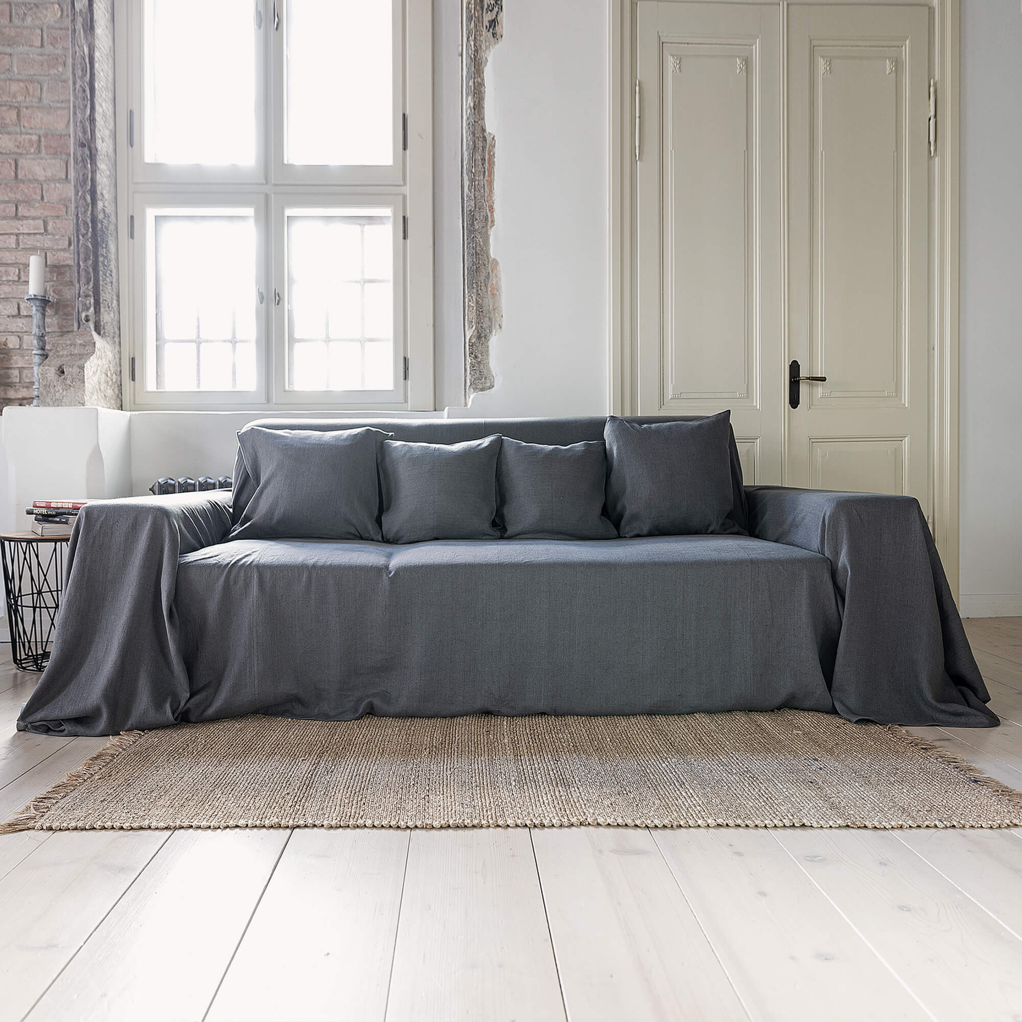 Renew your living space effortlessly with our charcoal grey linen couch cover. Its thoughtful design ensures complete coverage, extending gracefully over the arms. Discover the perfect balance of functionality and elegance with our collection today.