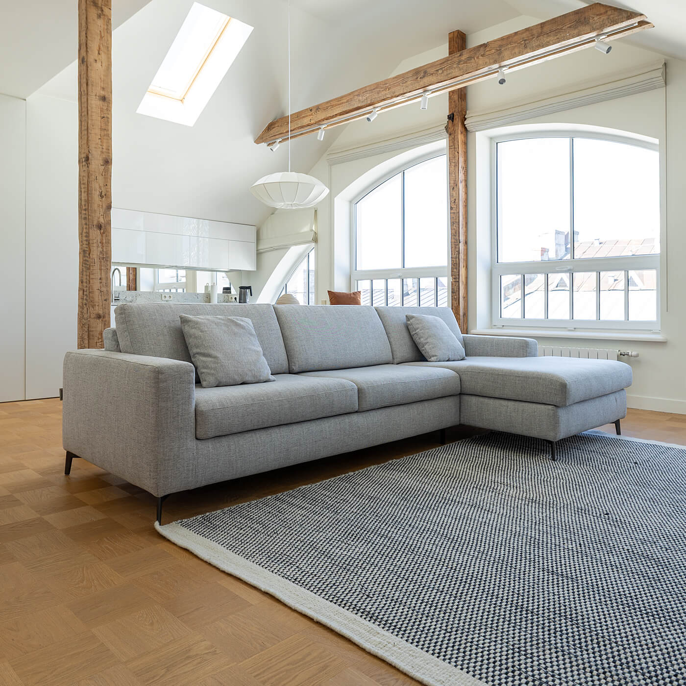 Grey corner sofa with chaise before the linen sectional cover