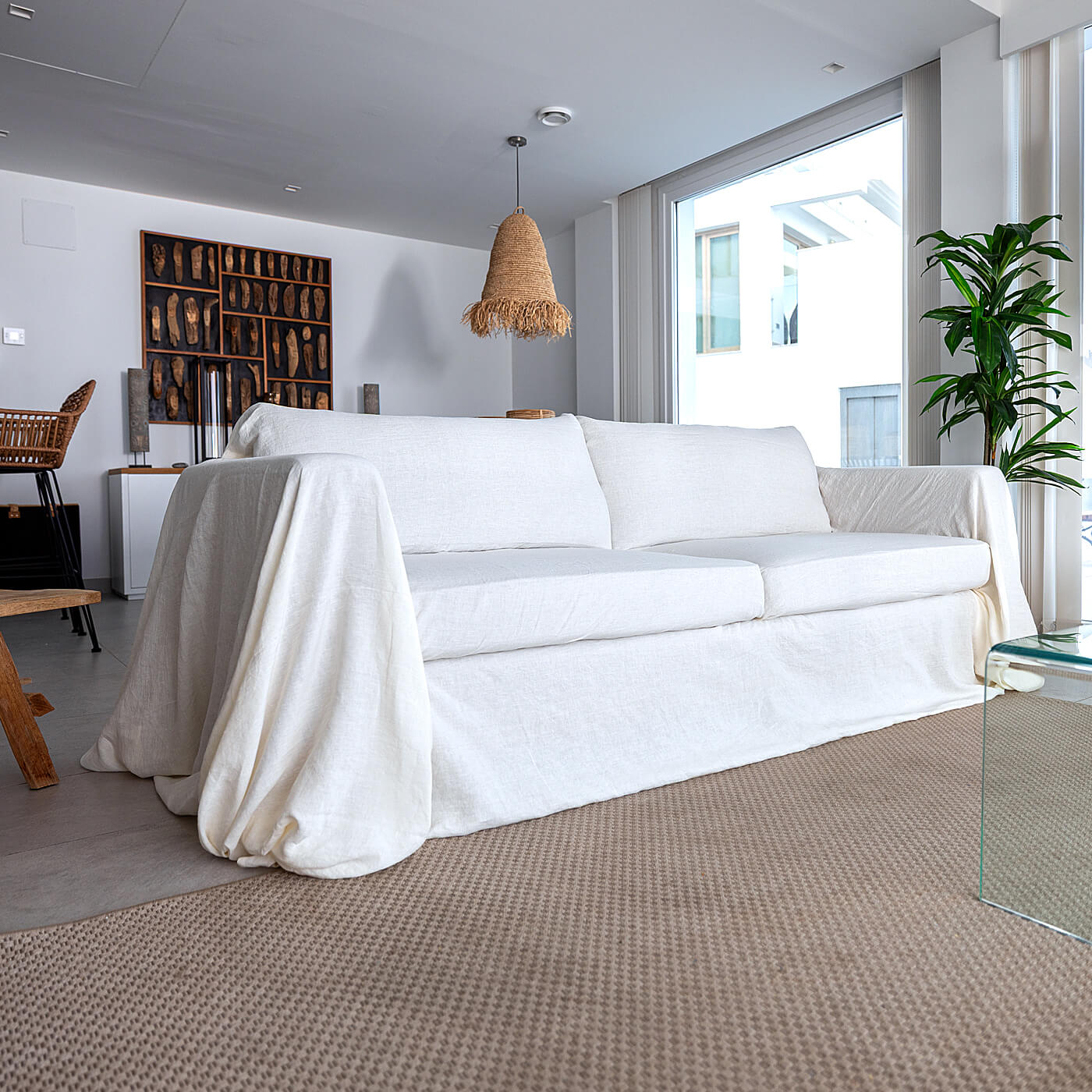 Sofa with a tucked white linen couch cover