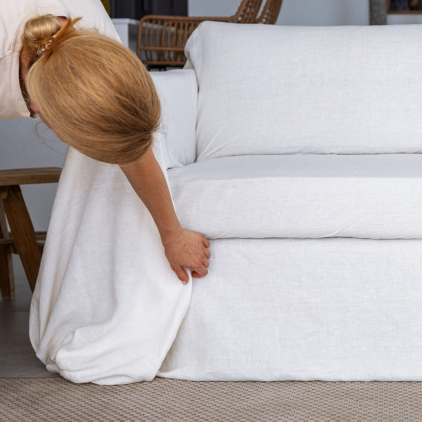 Arranging the linen fabric at the front of the sofa arm