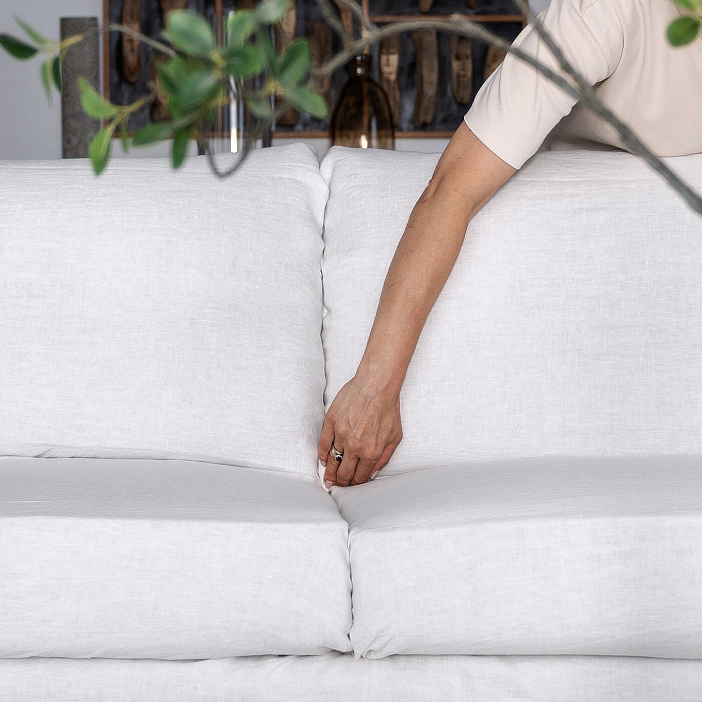 Tucking the cover between the back and seat cushions