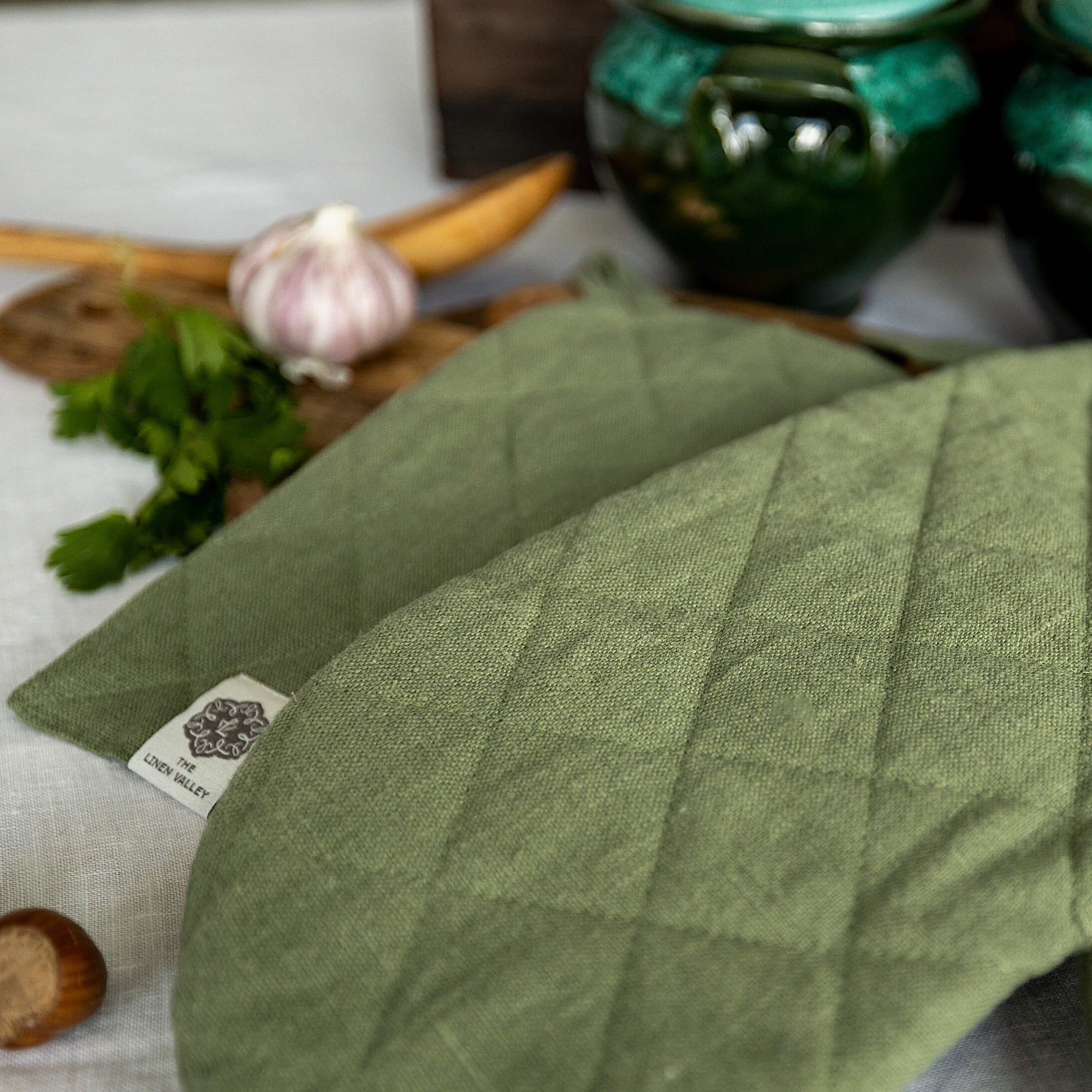 Crafted with care, these moss green linen oven mitten sets are the perfect companions for your culinary adventures.
