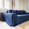 Navy blue linen couch cover designed and crafted to elevate your interior with a fresh look and great energy. It offers a practical solution for safeguarding your furniture against the playful antics of your beloved pets.