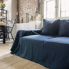 Navy blue linen couch cover designed and crafted to elevate your interior with a fresh look and great energy. It offers a practical solution for safeguarding your furniture against the playful antics of your beloved pets.