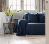 Navy blue linen couch cover designed and crafted to elevate your interior with a fresh look and great energy. It offers a practical solution for safeguarding your furniture against the playful antics of your beloved pets.