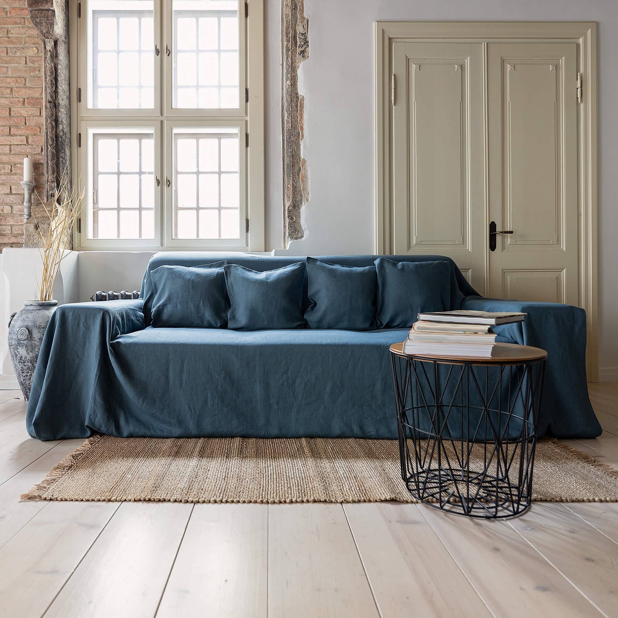 Ocean blue linen couch cover designed and crafted to elevate your interior with a fresh look and great energy. It offers a practical solution for safeguarding your furniture against the playful antics of your beloved pets. 