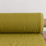 Rolled-up olive green fabric on a white background