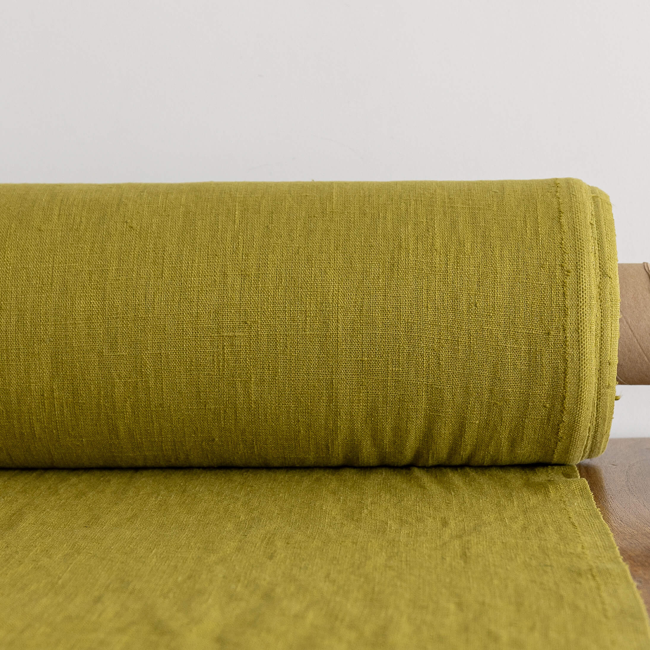 Rolled-up olive green fabric on a white background