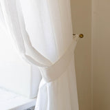 Our optical white linen curtain tie-back the perfect solution to keeping your curtains looking neat and stylish.