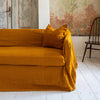 Introducing our Amber Yellow linen couch cover, crafted to enhance the beauty and functionality of your sofa. Designed to shield your couch from daily spills and stains, this cover offers both practicality and elegance.