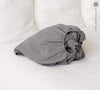 Our charcoal gray linen fitted sheet, the epitome of modern bedroom luxury.