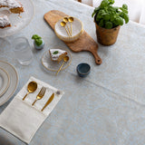 Sky blue floral linen-cotton tablecloth on a dining table, top view