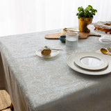 Sky blue paisley jacquard tablecloth draped over a table edge