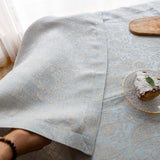 Mitred corner and double-folded hem of the sky blue floral tablecloth