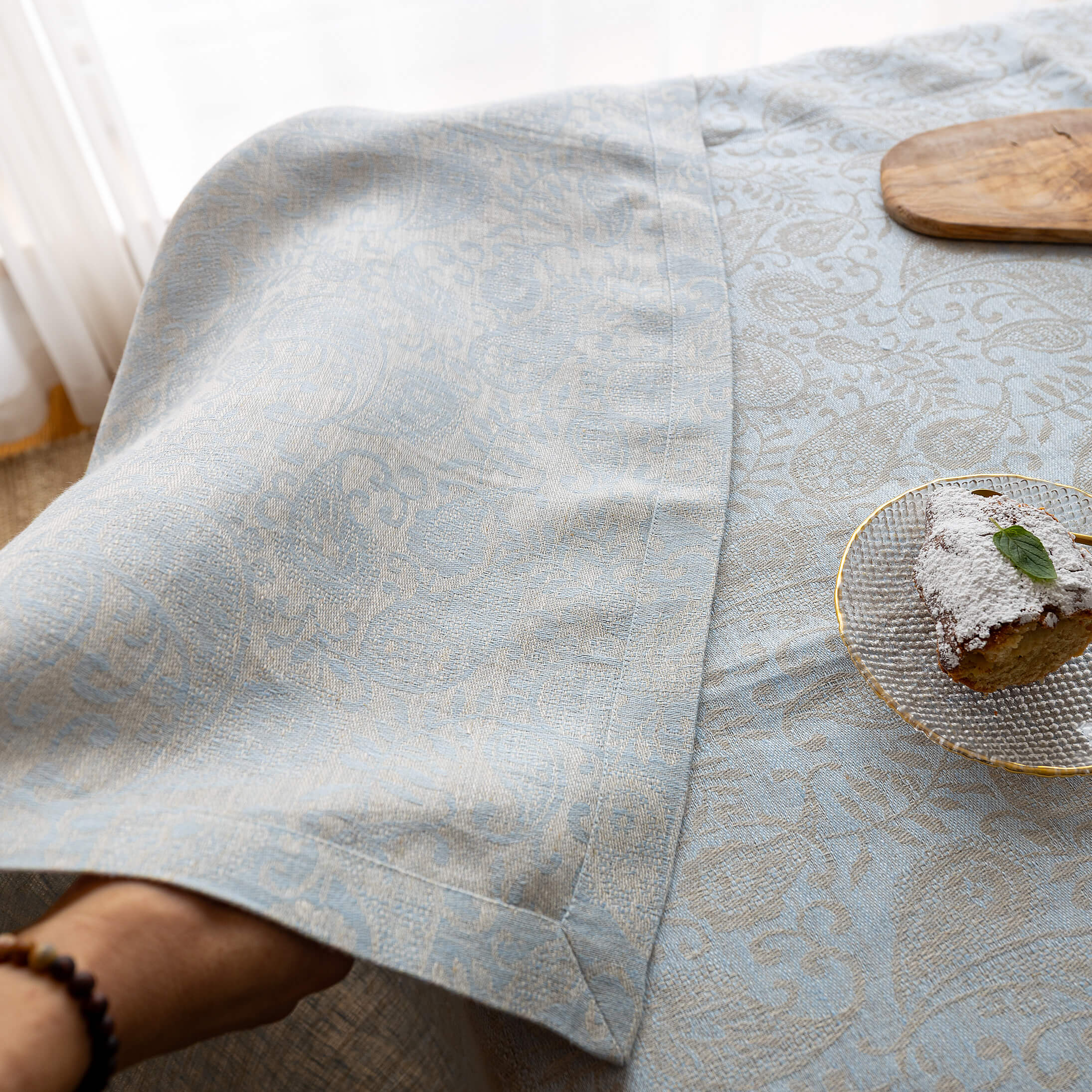 Mitred corner and double-folded hem of the sky blue floral tablecloth