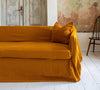 Introducing our Amber Yellow linen couch cover, crafted to enhance the beauty and functionality of your sofa. Designed to shield your couch from daily spills and stains, this cover offers both practicality and elegance.